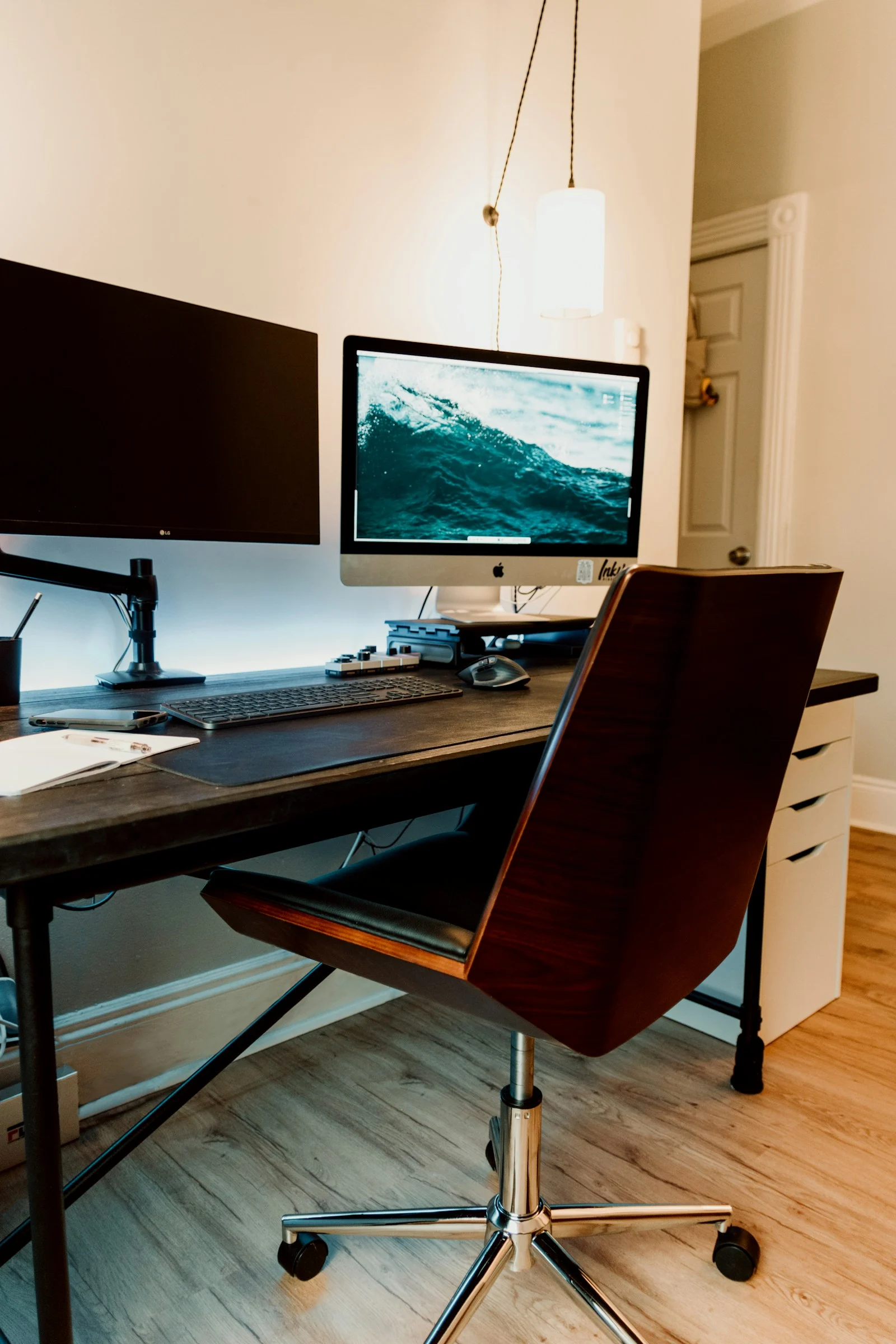 a desk with a monitor and keyboard on it