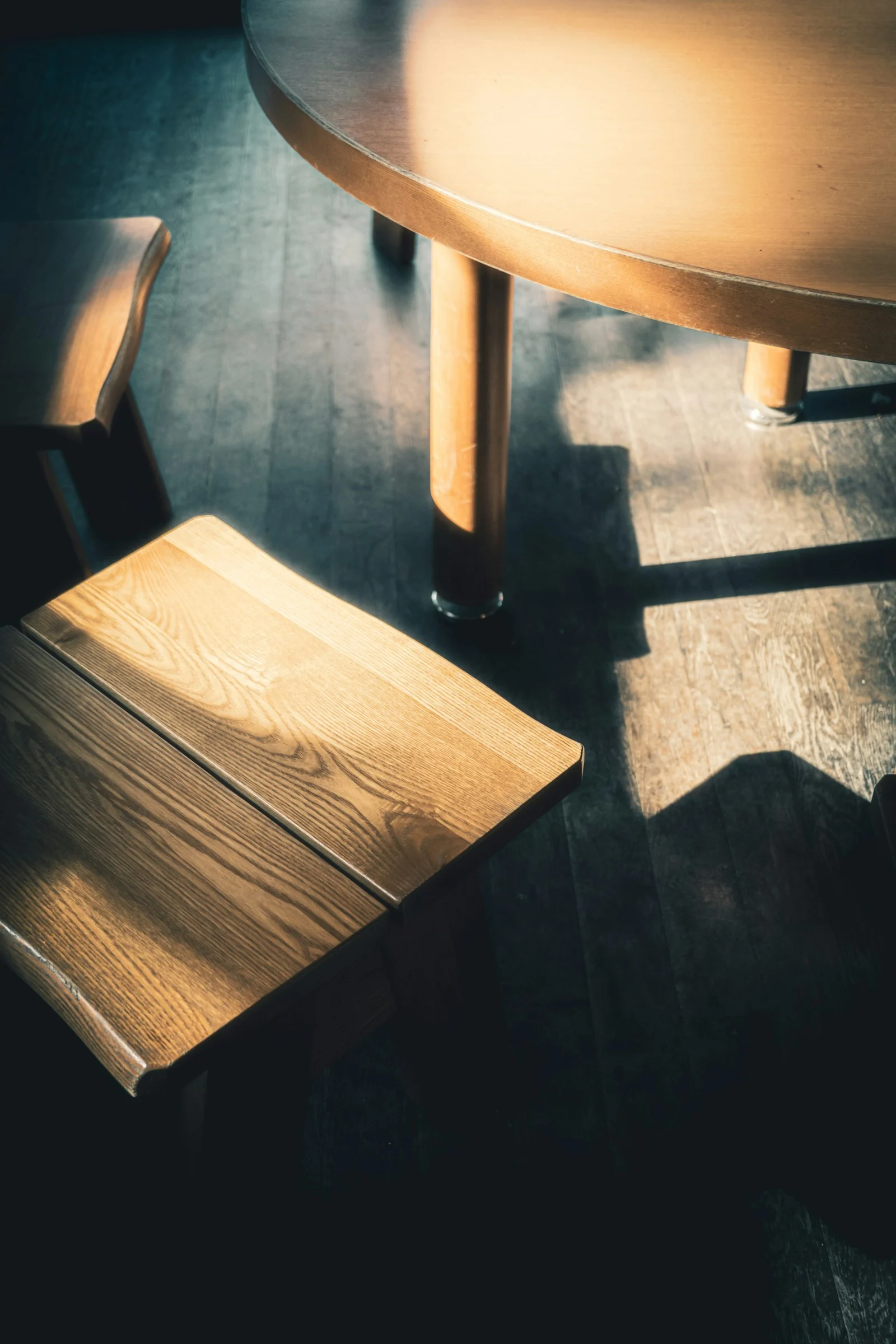 a wooden chair and table in a room