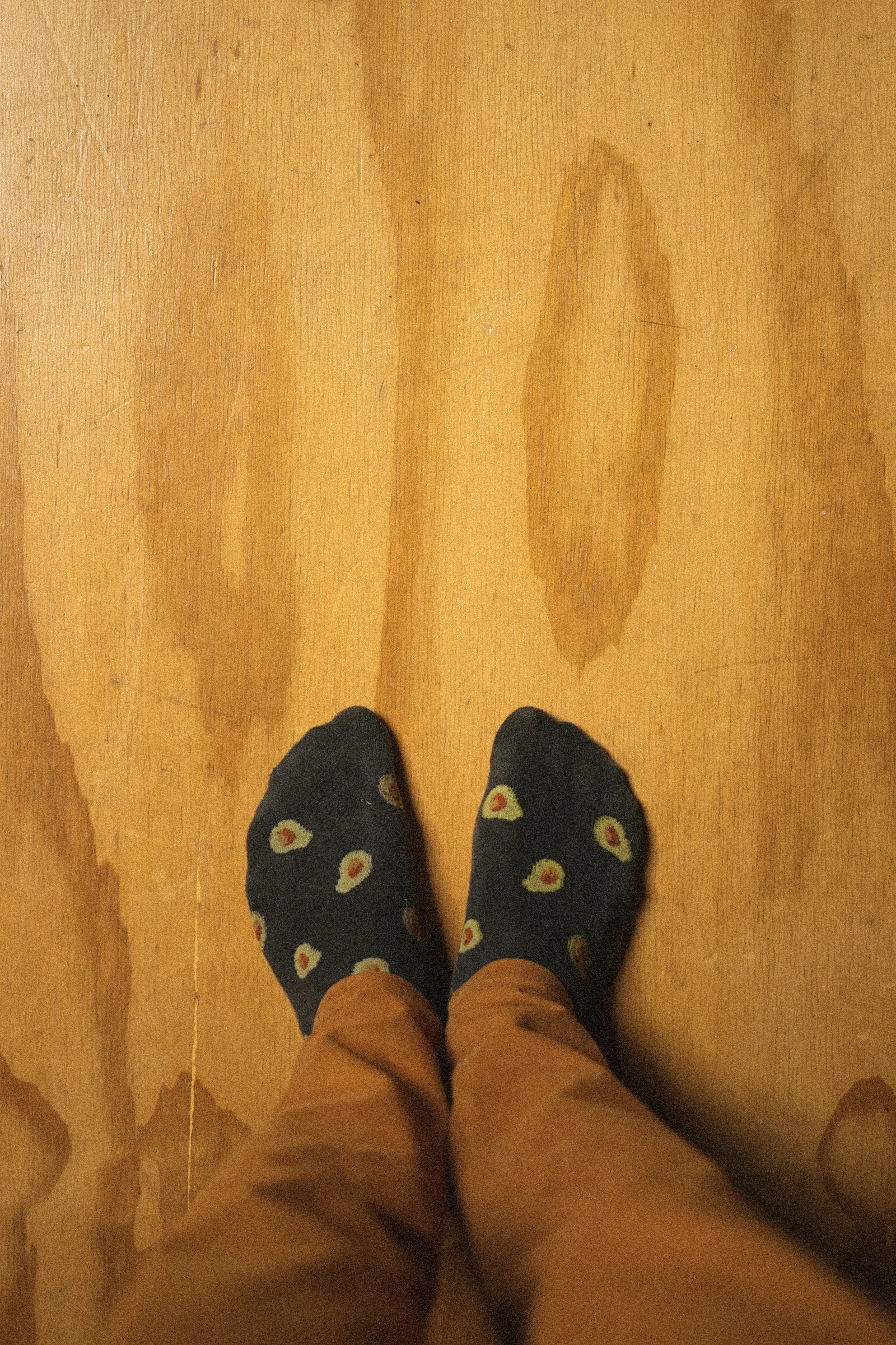 person wearing blue and yellow rubber clogs