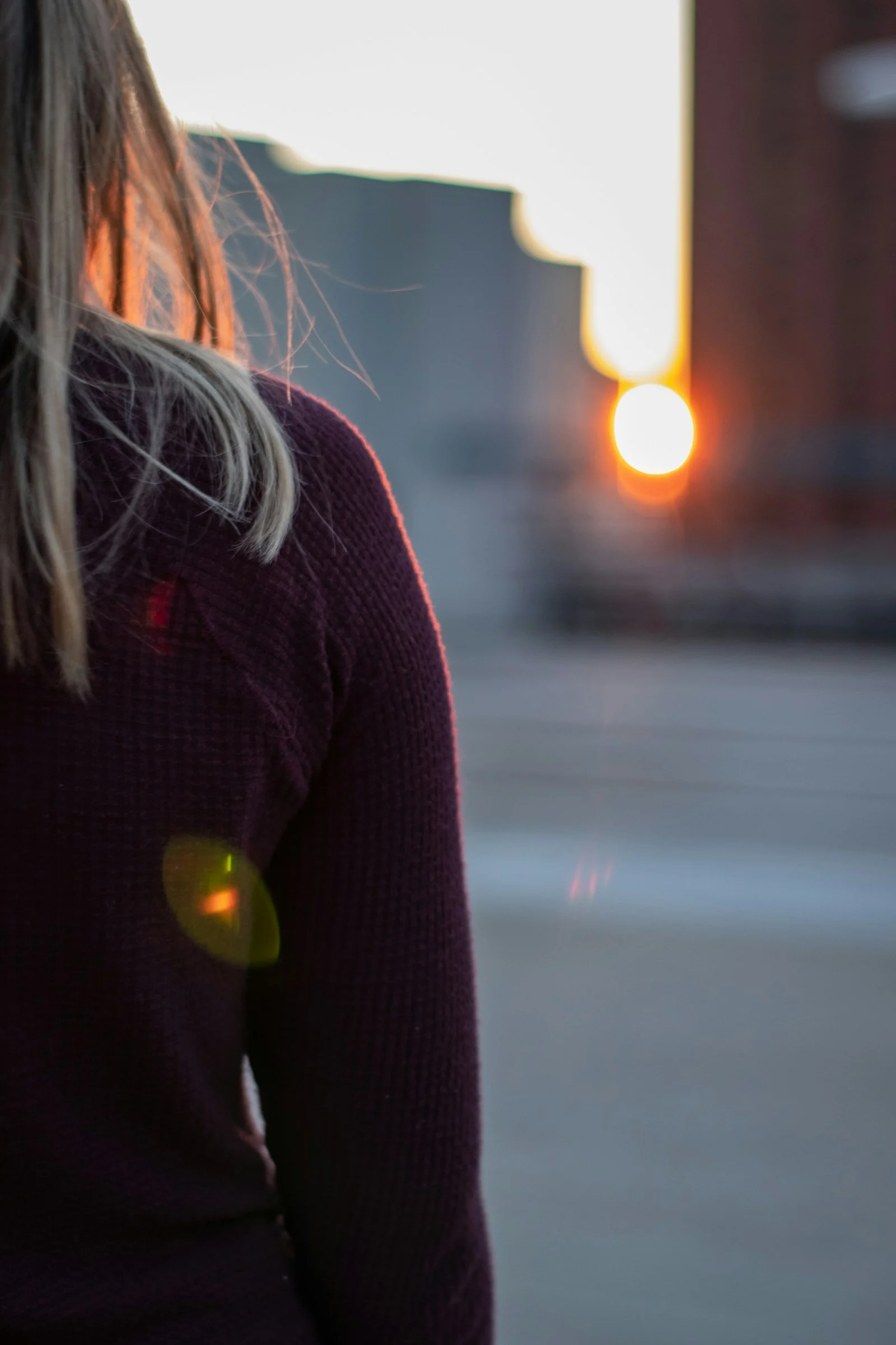Photo by Spencer Quast woman in black sweater standing on road during daytime